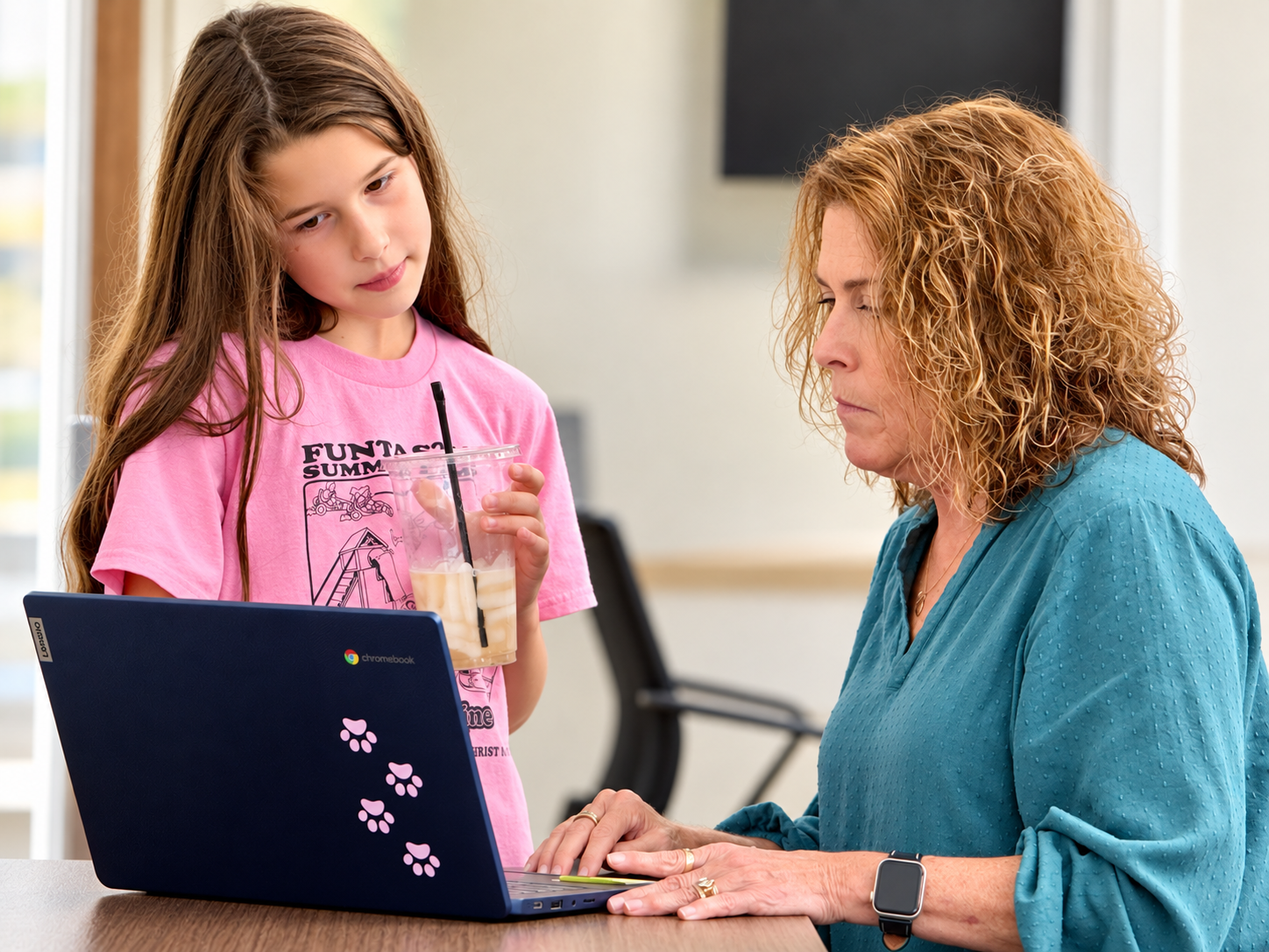 Personalized academic support in class-1 Teacher providing personalized academic support to a student at a laptop